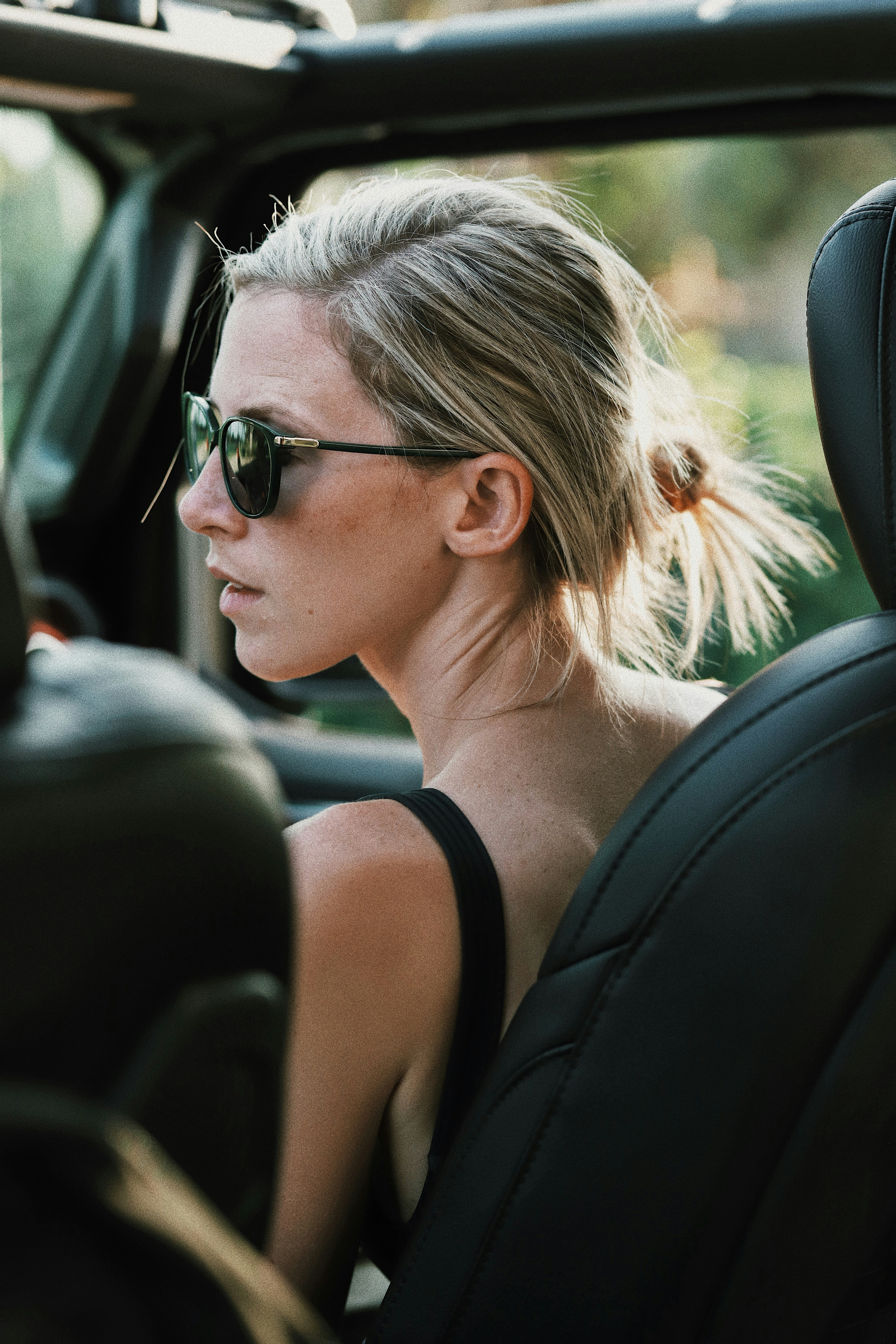 woman in black tank top wearing black sunglasses